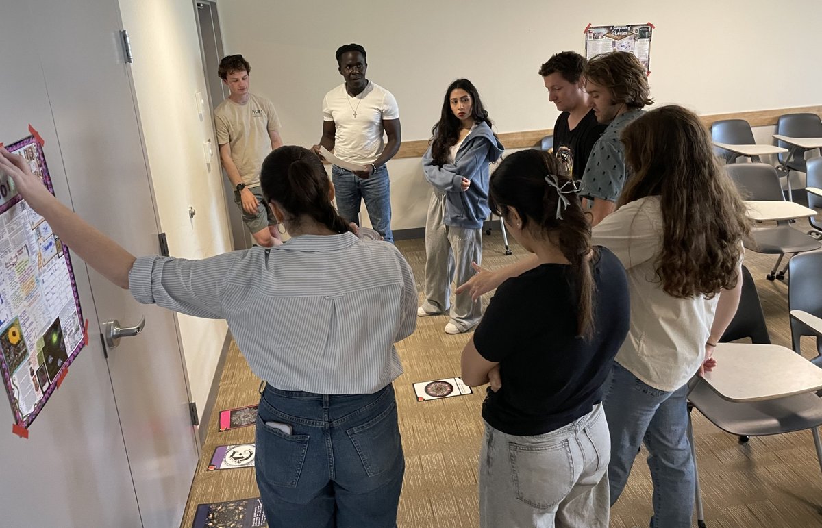 VALI concept cards laid out on the floor showing visual representations of AI concepts like meaning construction, abstraction, and creativity.